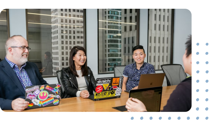 a group of professional software developers sitting at a desk